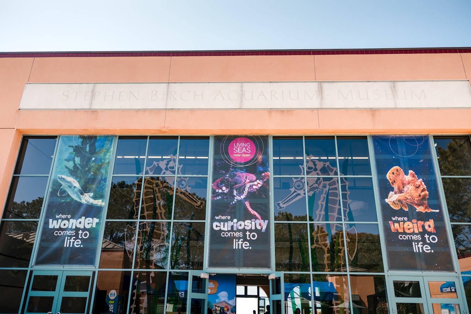 Exterior of the Stephen Birch Aquarium Museum with Living Seas Now Open banners