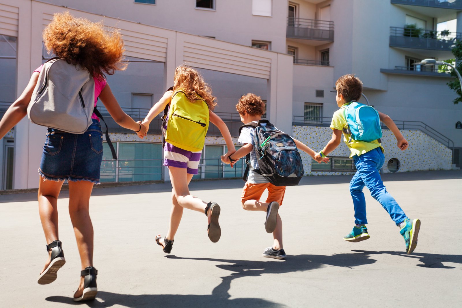 Kids with backpacks heading to school on the first day