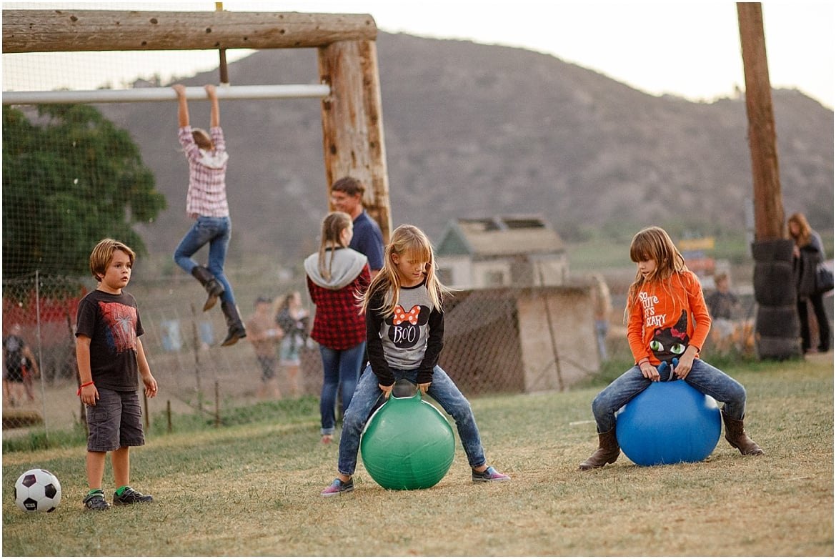 Children bouncing on hop balls and swinging from a bar at Oma’s Family Farm in Lakeside